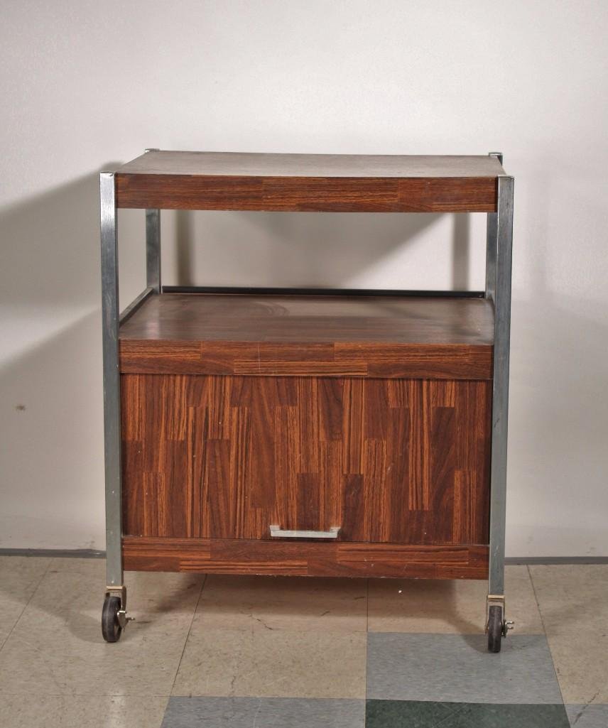 Utility Cart: Laminate Wood and metal modern style rolling cart, great for storing microwave or T.V. Measures 26 x 31 x 20. Has large storage area with door on the bottom. Shows some age and wear.