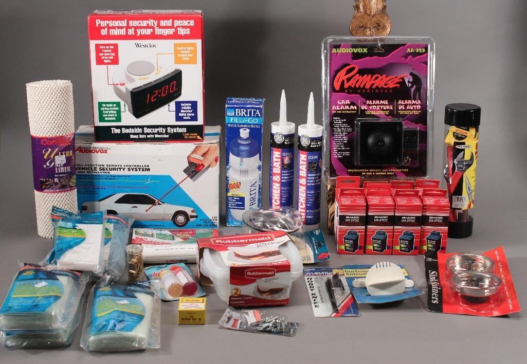 Home and Auto Goods: Audiovox full function remote controlled vehicle security system NIB, Audiovox Rampage car alarm, bedside security system NIB, tupper ware, clear silicone rubber sealant, hobby knife, Sharp 