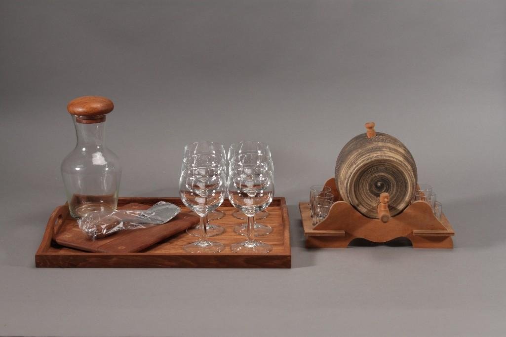 Wood and Glass Kitchenware: Six clear glass 5.5'' stemware, wooden serving tray, 10x6.5'' wooden cutting board, vintage beverage barrel with shot glasses, and more. In good condition.