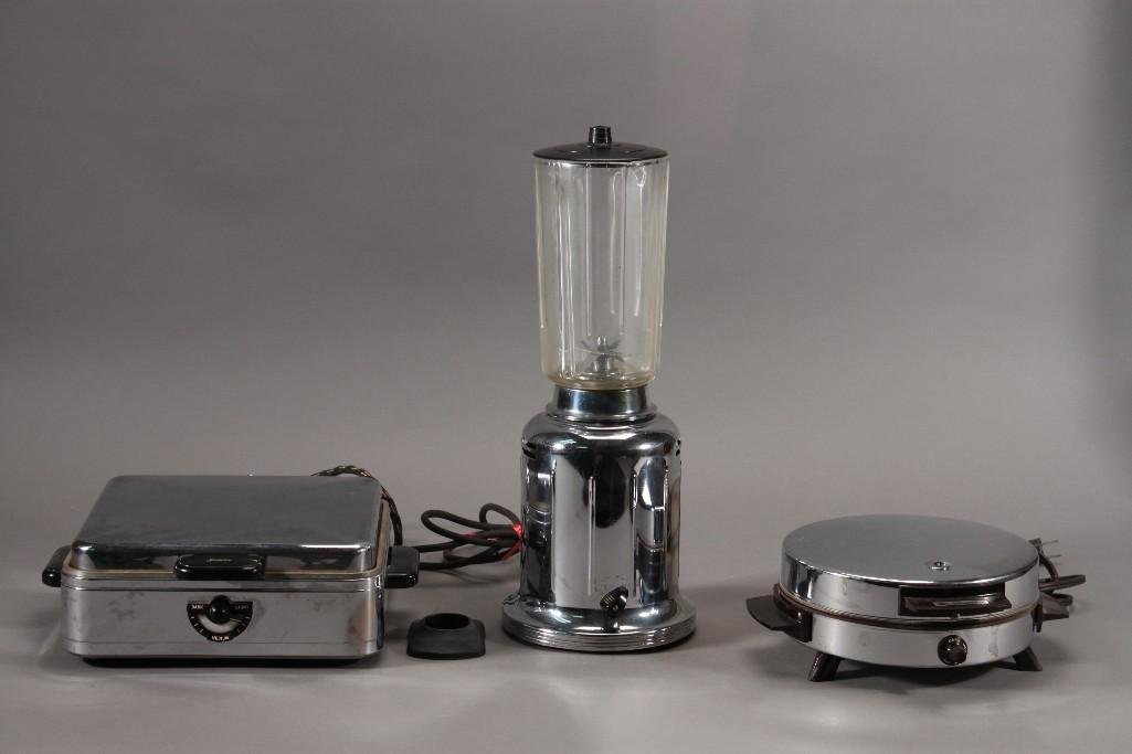 Vintage Kitchen Appliances (3): Sunbeam waffle maker Model W-2, Toastmaster waffle maker, and a Universal blender. All items are pre owned in good condition.