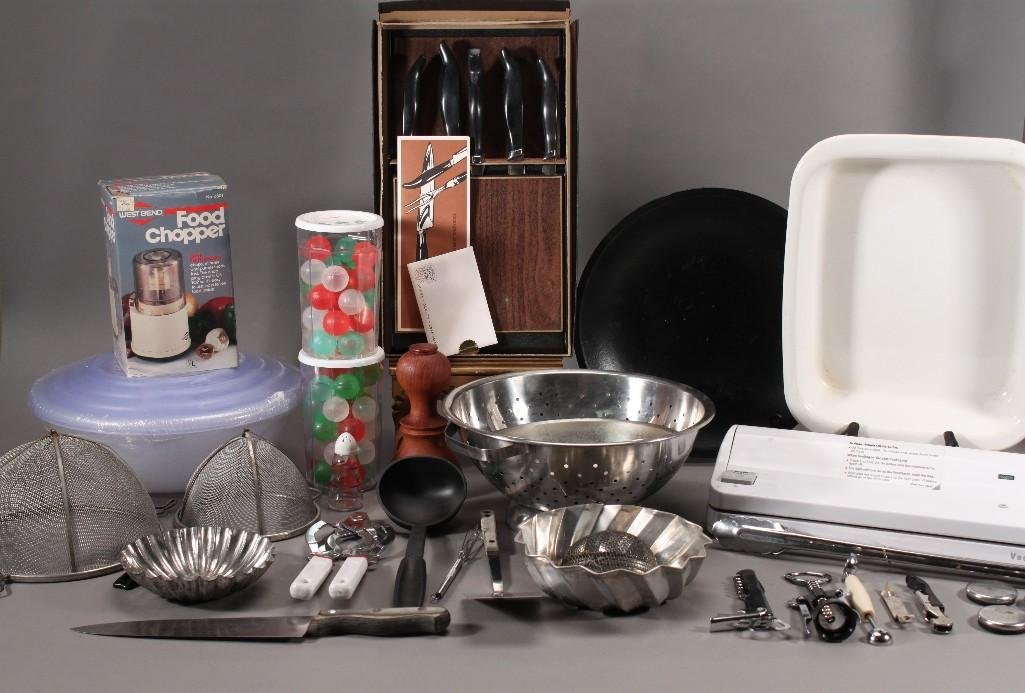 Kitchenware Assortment: Sterilite 8 piece tupperware set, Food Saver, two packs of Icers reusable ice cubes, baking pans, West Bend food chopper, hand crafted distinctive cutlery fashioned by master craftsmen, and more.
