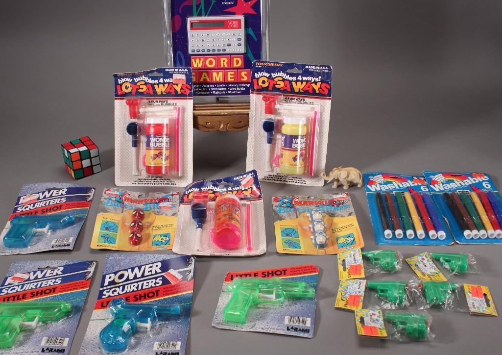 Children's Toys:  Rubix cube, bubbles, toy squirt guns, washable markers, hand held word game, and more. All items are new in original packaging besides rubix cube.