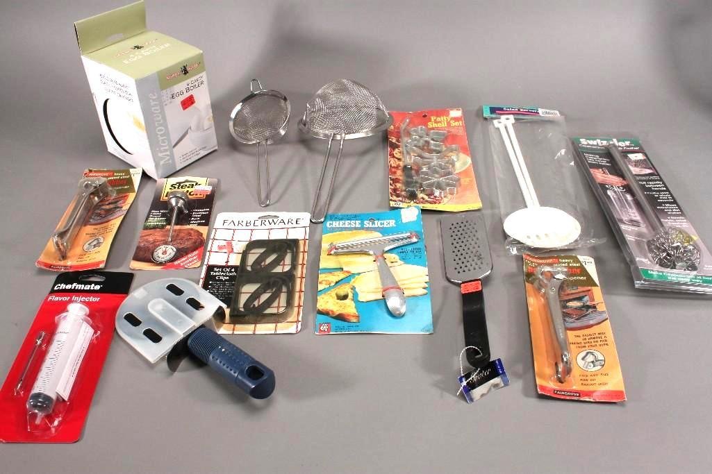Kitchen Items: Nordic Ware 4-cavity egg boiler, cheese graters, strainers,pizza cutter,salad servers and more.