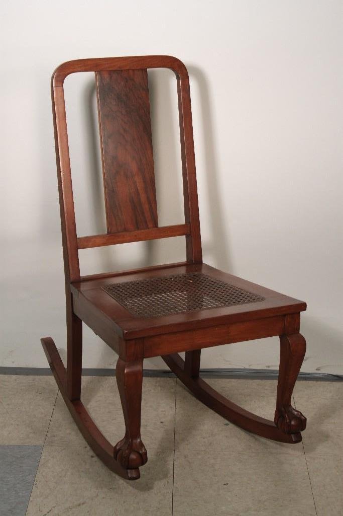 Vintage Rocking Chair: Cane seat, claw foot rocking chair in good condition. Measures 17 1/2 x 34 x 28''.
