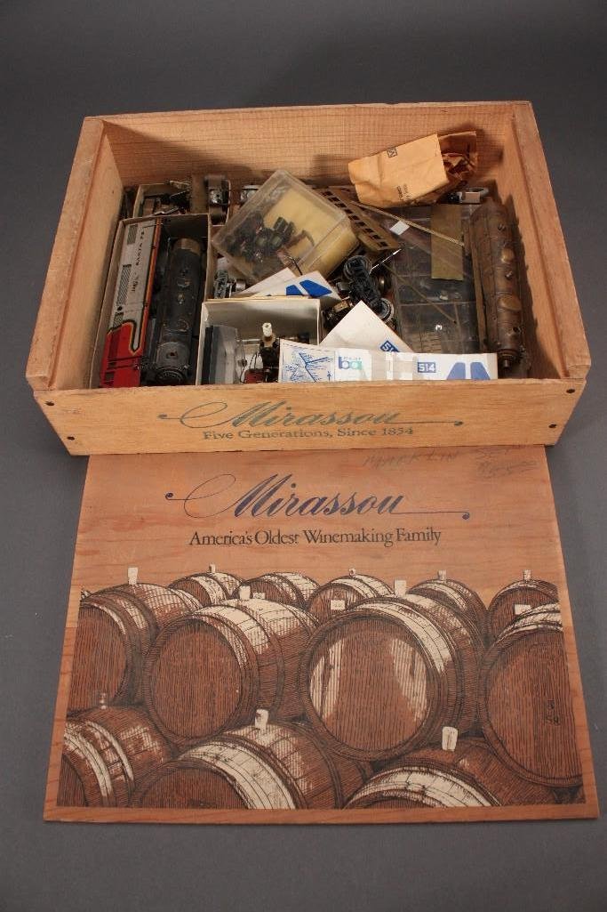 Vintage Train Parts and Accessories in Wooden Box: Assortment of small and medium size train parts, stickers, engines, and more. Inside of a Mirassou wine box.