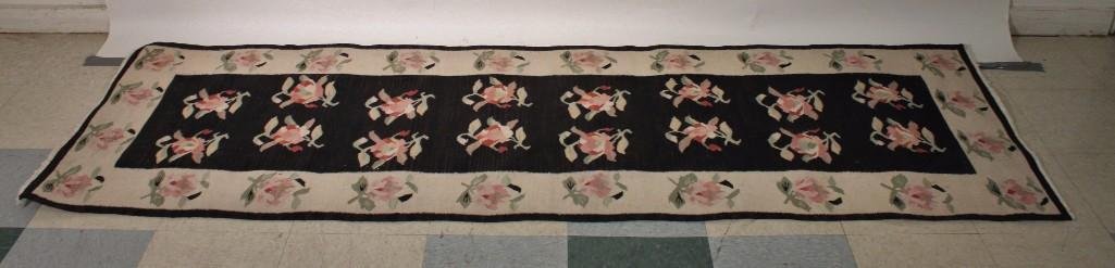 Floral Runner: Measures 97 x 31'', woven rug, no labels, black and cream background with pink and green floral design.