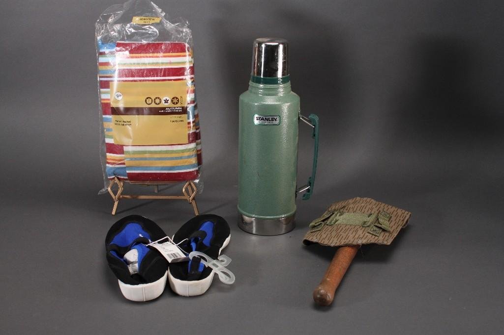Camping Supplies: Stanley 2 Qt. vacuum bottle, West Marine aqua socks, vinyl tablecloth, and camping shovel.