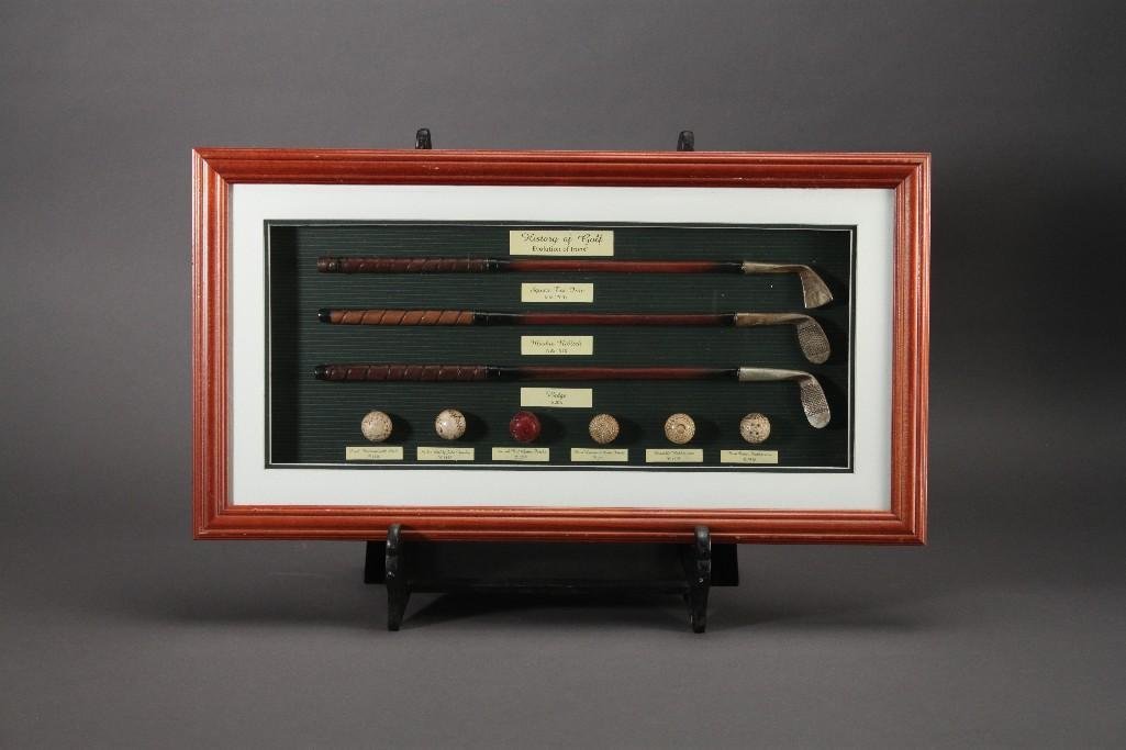 History of Golf Artwork: "Evolution of Irons", includes miniature irons and golfballs dating 1700's to 1930, frame measures 22"x12"x1 1/2".