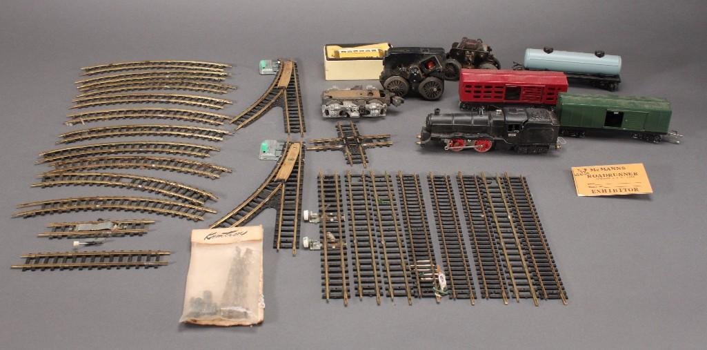 Toy Train Parts and Tracks: Made in Japan locomotive and three car set, measures 6" long, 3 1/2th Japan Lake Shore car, 3 locomotive parts one Lionel, and several train track pieces.