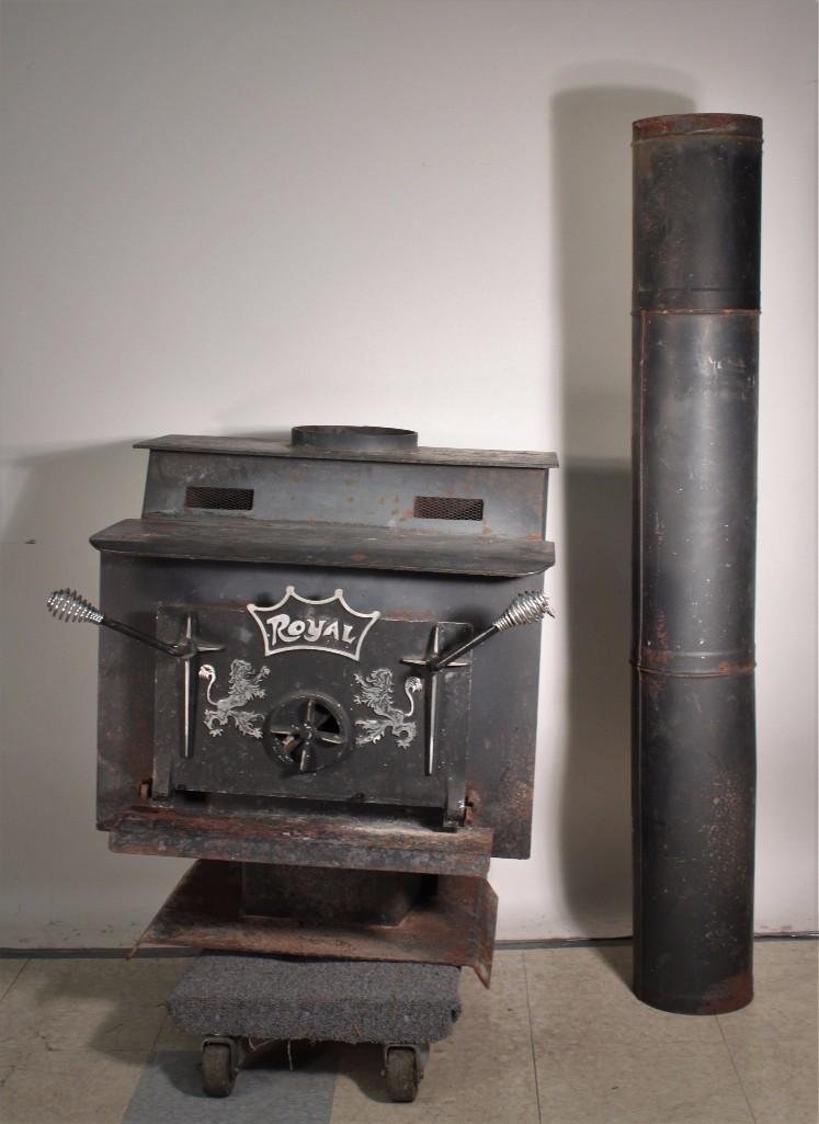 Royal Wood Burning Free Standing Fireplace: Shows age and wear, 27.5''x35''x24'', includes chimney, has white design.