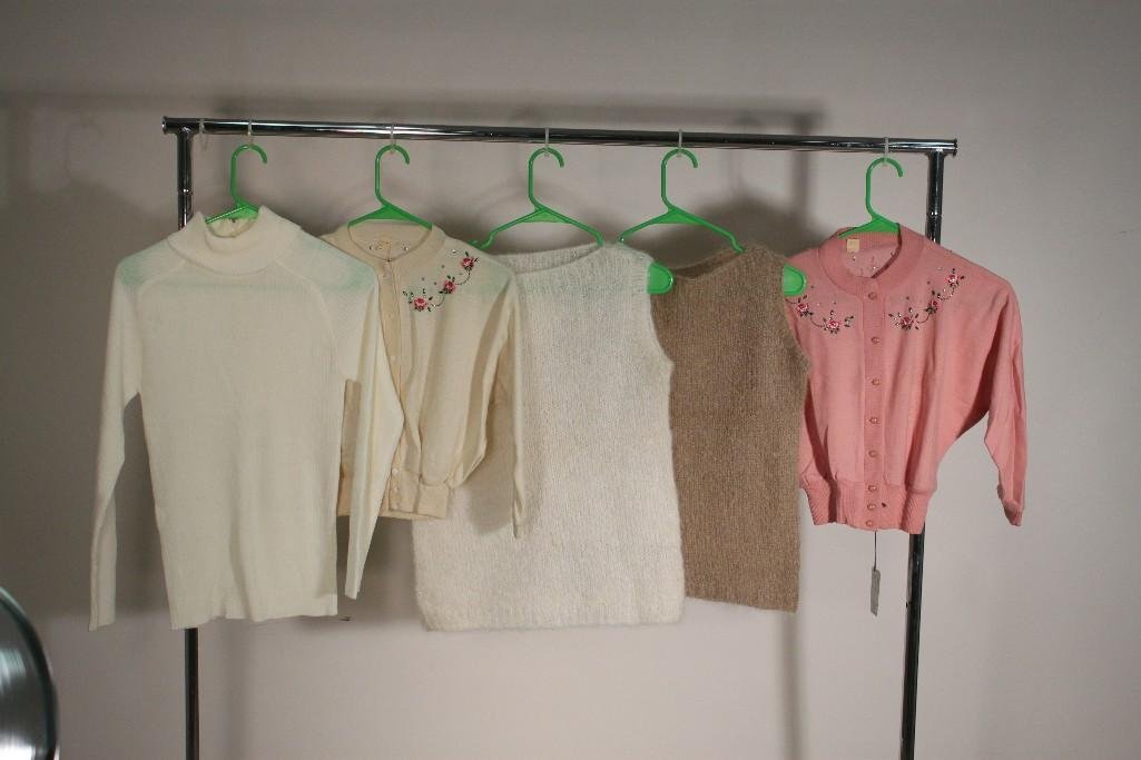 Ladies Tops (5): Two Californias Colony Casuals Colony Creations button up sweaters, two knitted sleeveless shirts, and a San Angelou turtle neck. All items are in good condition. White sweater with flowers is size 16