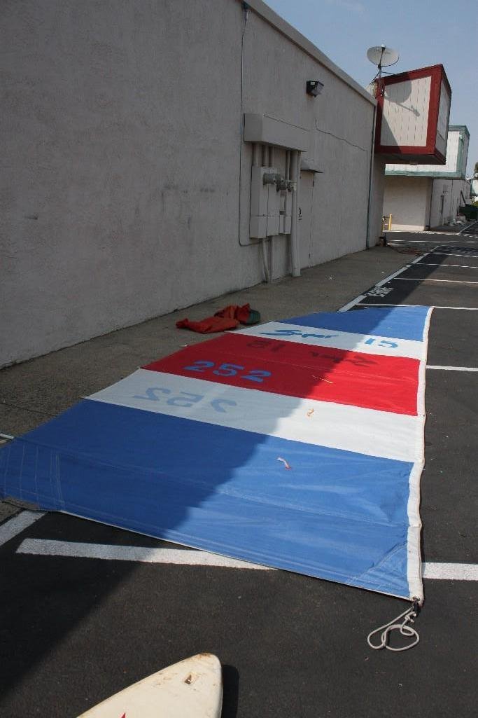 Catamaran Sail: Red, white and blue in color, marked Super 15 252, very good condition. Measures 8' X 23'. Comes in canvas carrying bag.