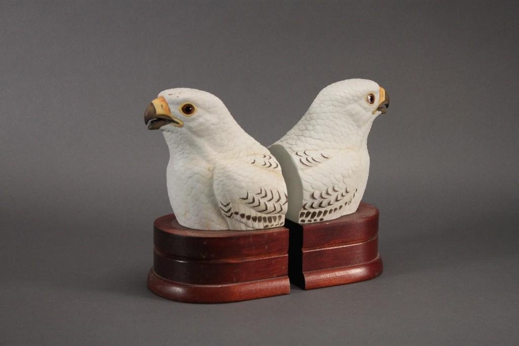 Andrea By Sadek Falcon Bookends (2): Porcelain and wood bookends measure 8.5" tall and aremarked on the bottom. Good condition, some scuffs.