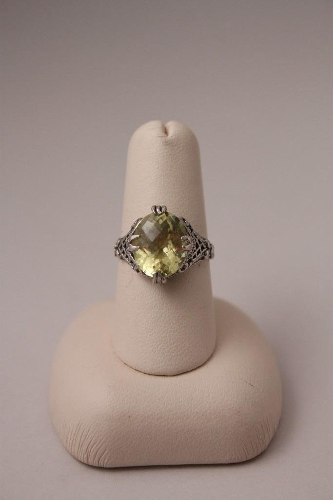 Oval Lemon Citrine and Sterling Silver Ring: Has one stone, marked ster, good condition.