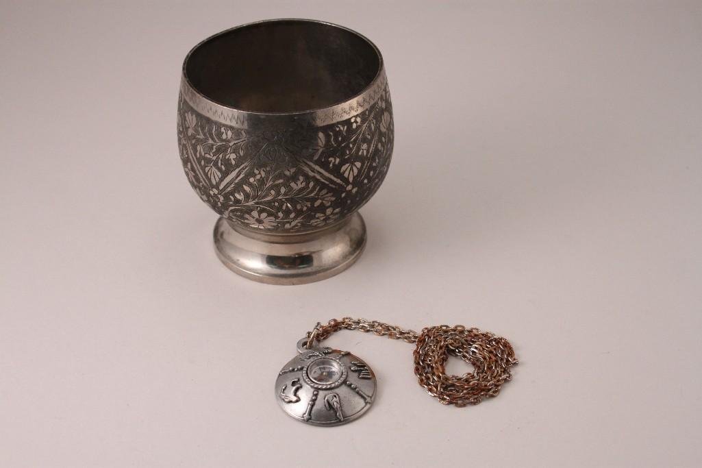 Metal Cup and Compass Necklace (2): 3.5'' tall metal floral design cup (shows age and wear) and a compass necklace (pre owned).