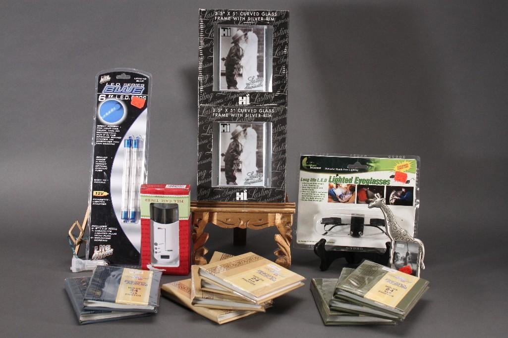 Assorted Home Goods: House Wares 3.5''x5'' curved glass with silver rim frames, nine 24 4x6'' photo albums, pill case timer, +1.50 lighted eyeglasses, and more. Items are new or in good condition.