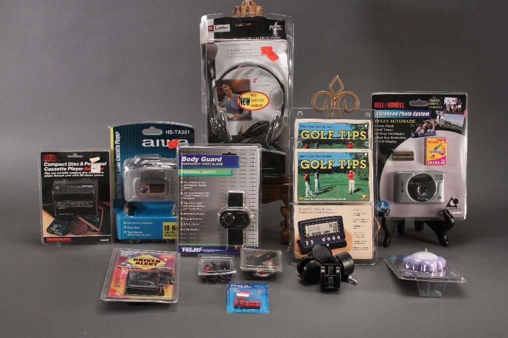 Electronics: Driver alert body alarm, Compact discand personal cassette player adapter, Body Guard personal safety, Golf Tips, Bell Howell advanced photo system, AiwaAM/FM stereo radio cassette player. All items a