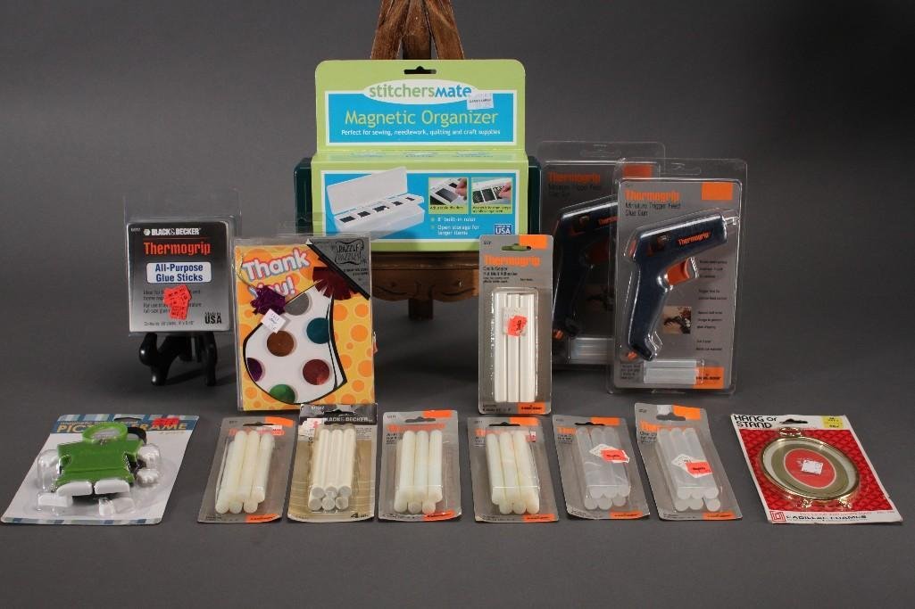 Craft Supplies: Thermogrip glue gun (2), eight packs of glue sticks, magnetic organizer, thank you notes, bobble head picture frames, and small oval frame. All in original packaging.