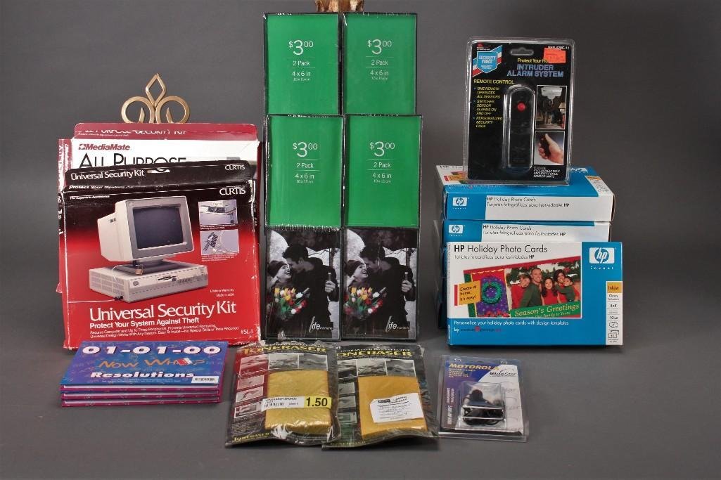 Office Supplies: Six packs of HP holiday photo cards, intruder alarm system, hands free head set, photo frames, toneraser, and more. All items are new in original packaging.