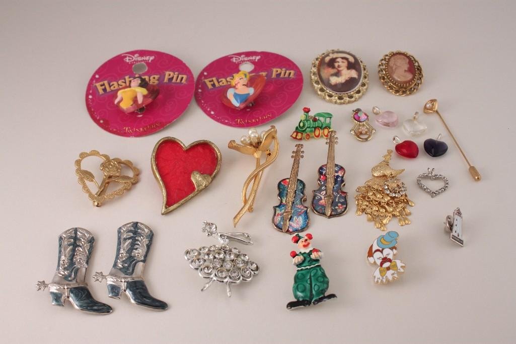 Costume Jewelry, Pendants, and Pins: Two Disney flashing princess pins, two cowboy boot brooches, heart pin, clown pin, gold tone FE pin, silver tone rhinestone pendant, and much more.
