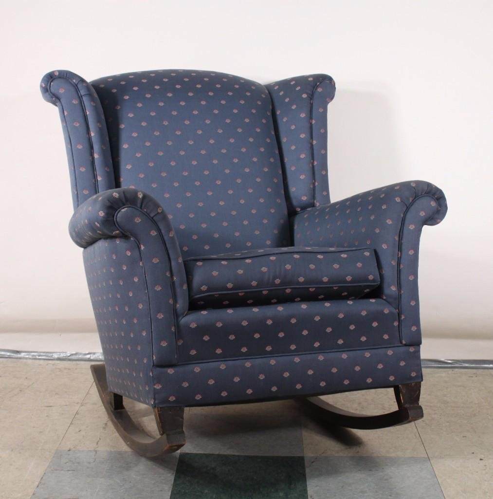 Upholstered Rocking Chair: Nice blue fabric, pink fan design with wood rocker base. Measures 33 in w x 36 in h. Rails are 36 in deep. Fabric is in very good condition, only light scratches on wood base.