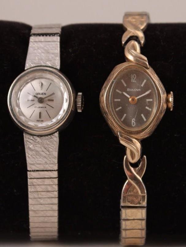 Gruen and Bulova Ladies Watches (2): Gold tone Bulova watch with stretch band and a silver tone Gruenwatch and band.