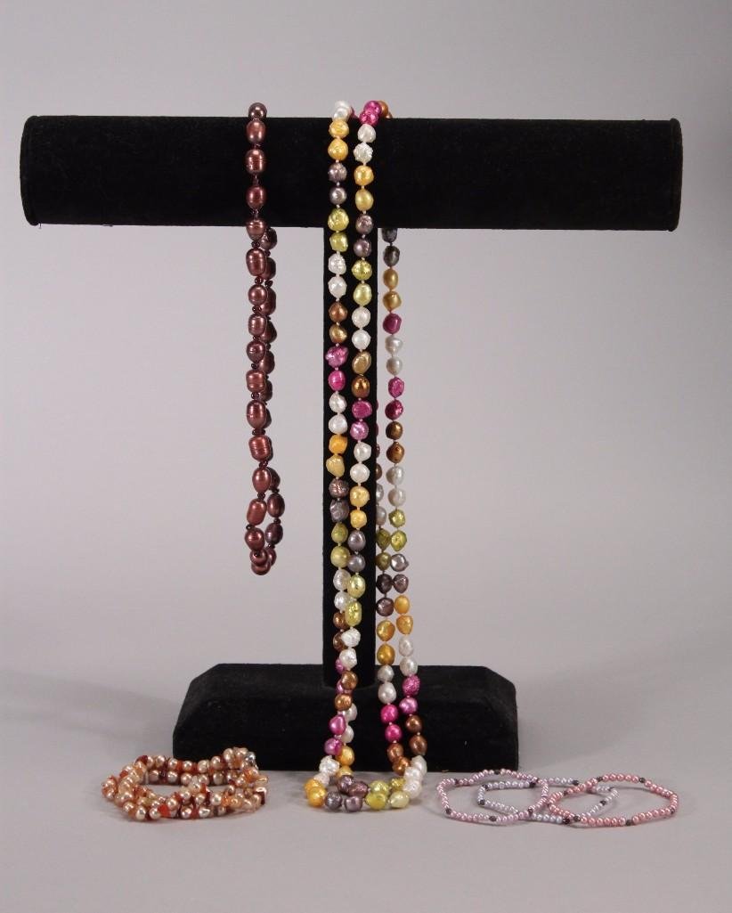 Fresh Water Pearl Jewelry: Multi-color strands include 30" necklace with green, pink, gold, and brown. Light plum colored 10" necklace, and four bracelets.