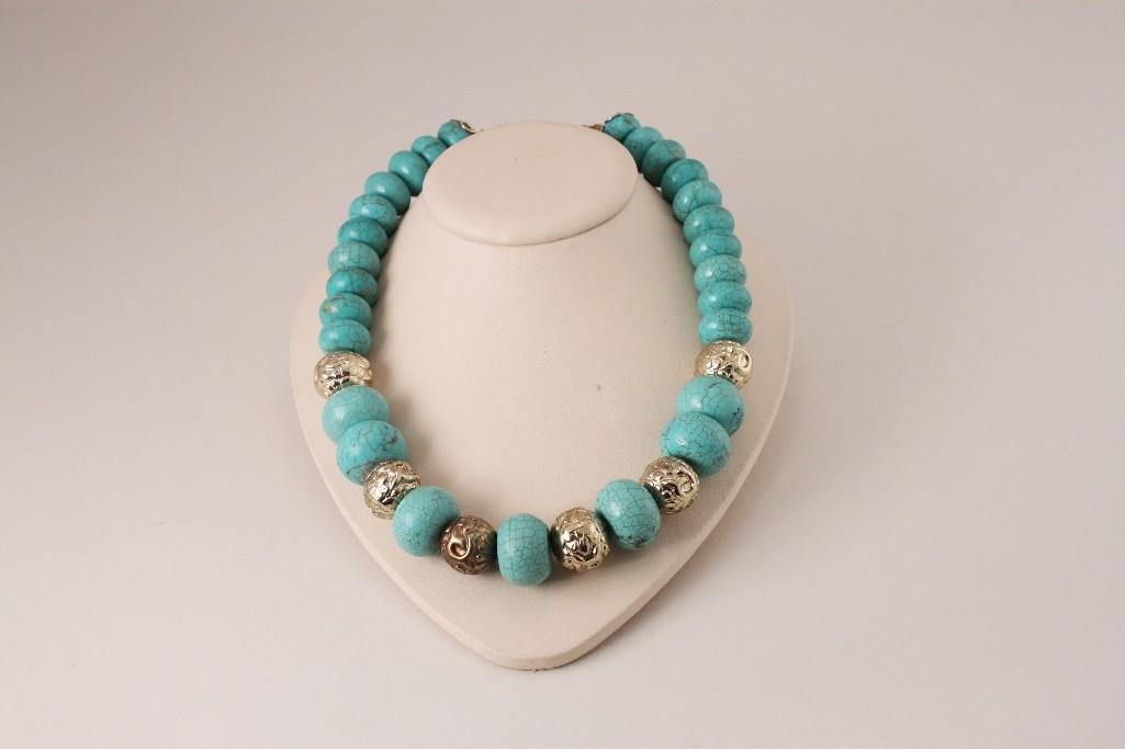 Howlite Turquoise Necklace: Turquoise and gold tone beads (one dark colored bead), measures 9.5'', in good condition.