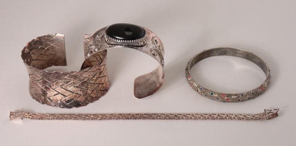 Ladies Sterling Fashion Bracelets (4): Two cuff bracelets, one with weave design and one with black center stone, one bangle bracelet, and one chain link bracelet with safety clasp marked Italy Milor.