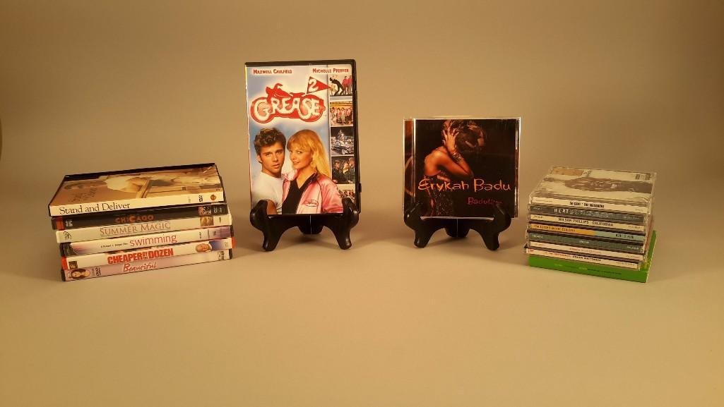 Assorted DVD's and CD's: DVD titles include Beautiful, Summer Magic, Cheaper By The Dozen, Chicago, Stand and Deliver, Grease, and more. CD titles include 50 Cent, Rent, Grease, On Broadway, and much more.