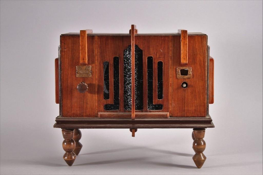 Vintage Troy Radio Mfg Co Wooden Radio: Model no 15, ser. 5574, now in working condition, shows signs of age and wear, leg is loose, and missing a knob on the front.