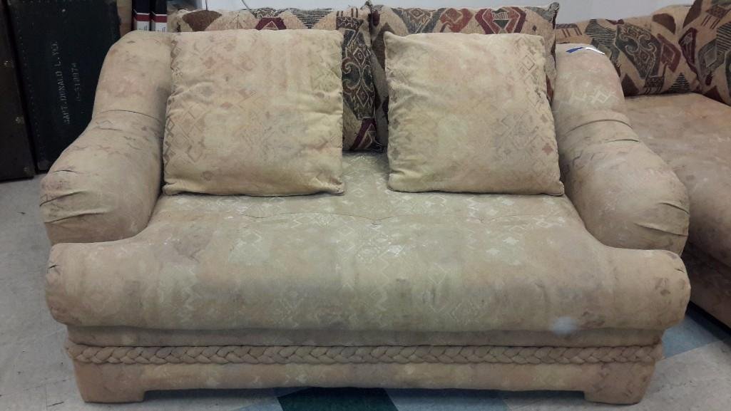 Sahara Love Seat: Saraha Alayne love seat, includes decorative pillows, has braid design on the bottom of the couch, shows signs of age, otherwise in good condition, measures 69'' long, 30'' tall, 44'' deep.