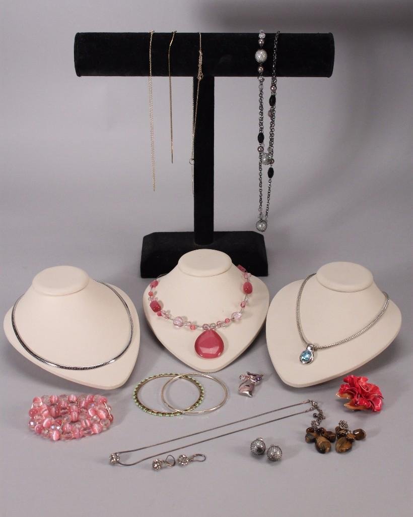 Costume Jewelry: Bracelets, pierced earrings, pink beaded necklace and stretch bracelet, silver tone and gold tone necklacesand rhinestone earrings and pendant.