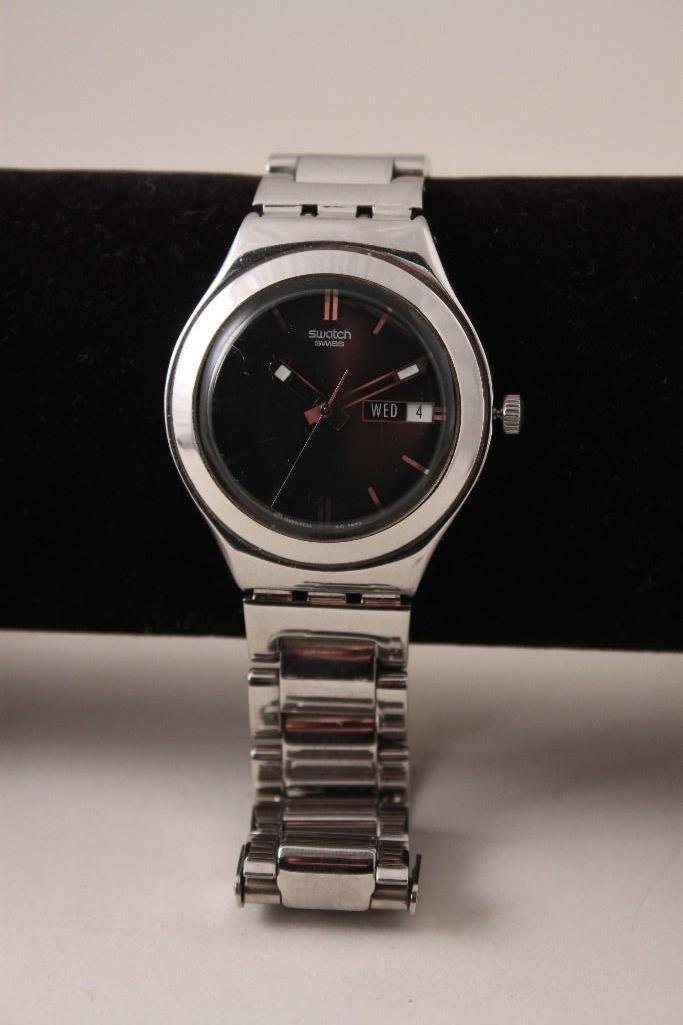 Swatch Irony Wrist Watch: Stainless steel back Swiss made, patented water-resistant silver tone band with black face; no original box.