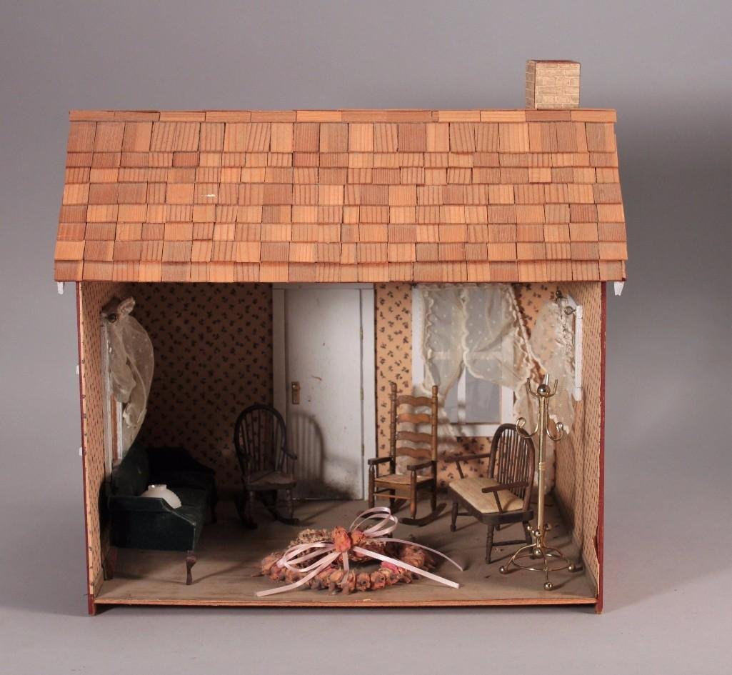 Vintage Wooden Doll House: Measures 15" x 14", wooden furniture includes Victorian style couch, hat stand, two rocking chairs, a wooden bench, and more. House shows age and wear otherwise in good condition for age.