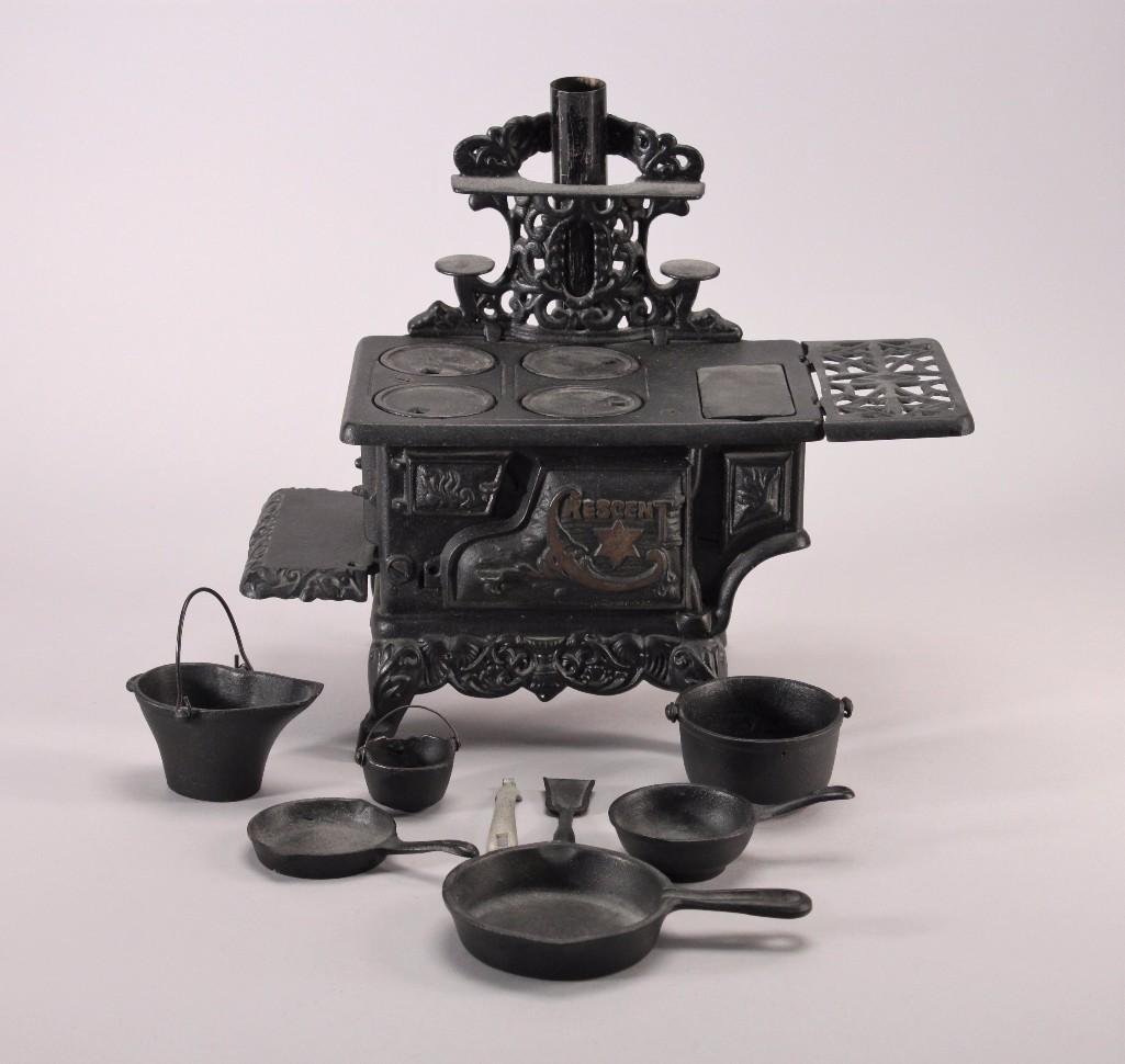 Cresent Cast Iron Stove Toy (19 pc): Black cast iron stove with removable shelves, burners, oven door, pots, pans, and handles. Good condition.