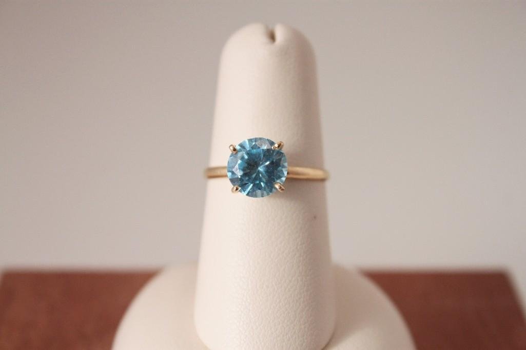 14 K YG Blue Stone Solitaire Ring: Blue topaz? round stone prong set on 14 K band, approx. size 5.