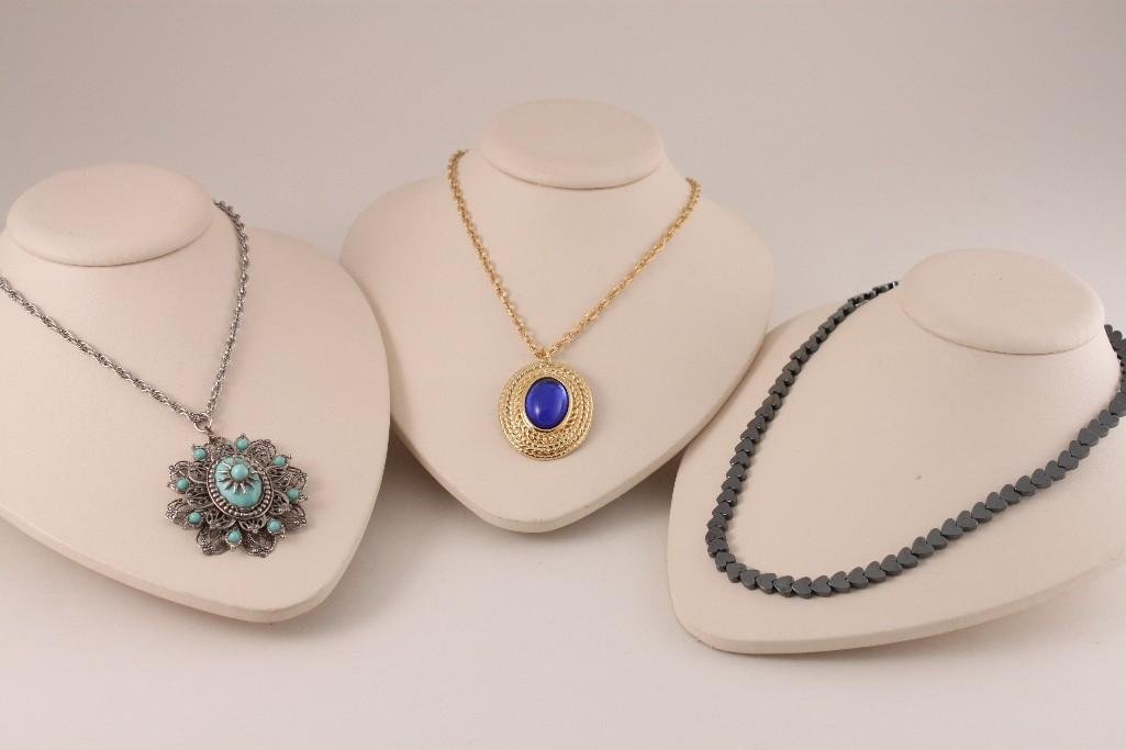 Ladies Pendants and Necklace (3): Silver tone chain with turqouise colored beads, gold tone chain with dark blue center stone pendant and a silver tone heart shaped link necklace. All in good condition