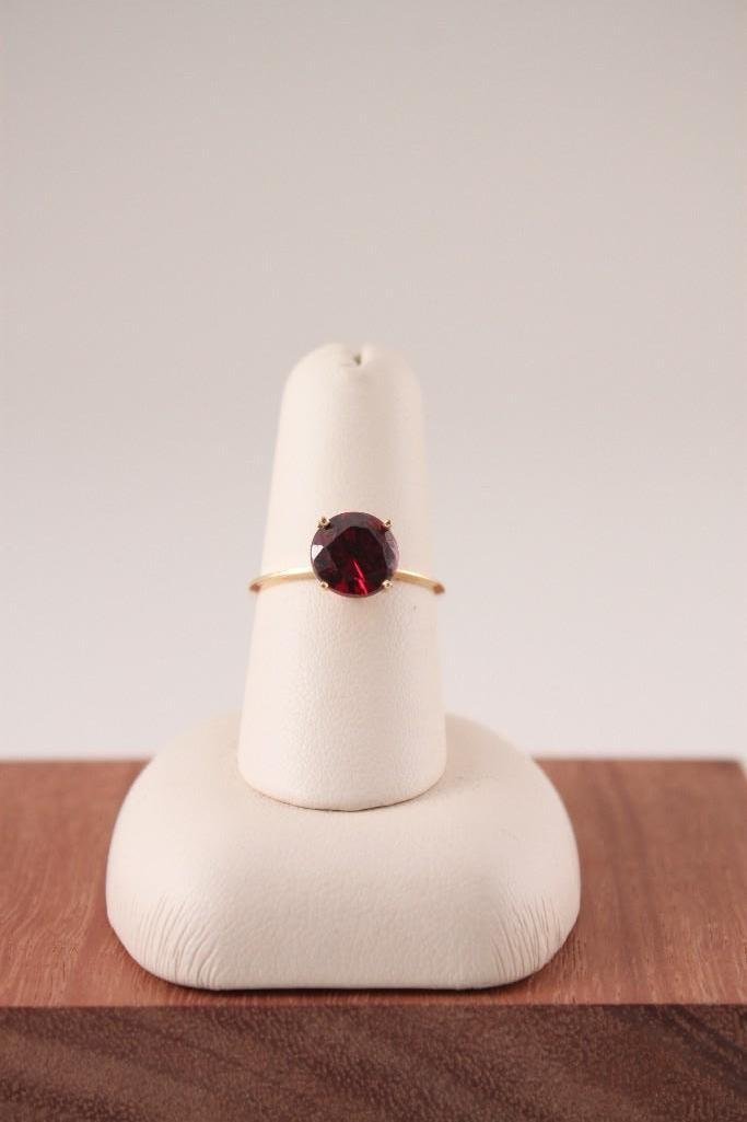 Ladies 14 KT YG Solitaire Ring: Delicate 14ktyg band with a round red prong set stone, approx. size 5-6.