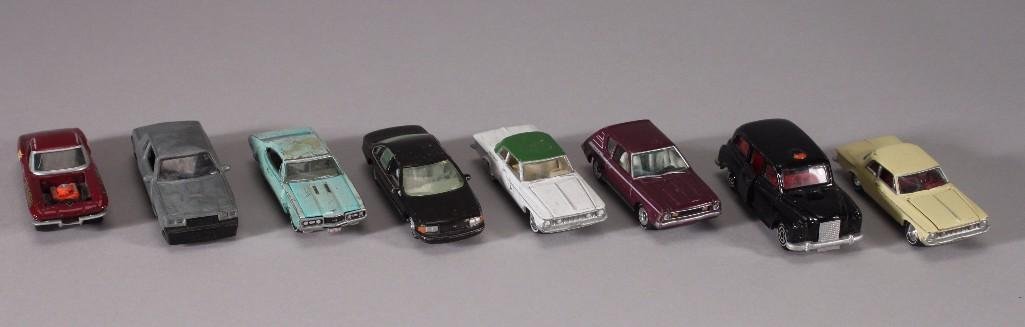 Vintage Johnny Lightning Metal Cars (8): Six cars marked Johnny Lightning, one marked Jada Toys, and one marked Real Toy. Cars show age and war otherwise in good condition for age.