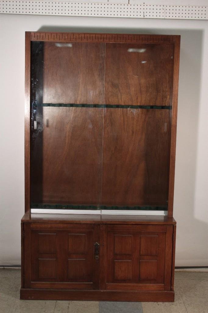 Gun Display Cabinet: Wood cabinet has plywood back, two glass sliding doors, two cabinet doors (one missing handle), measures 74.5" x 18" x 43.5", shows age and wear otherwise in good used condition.