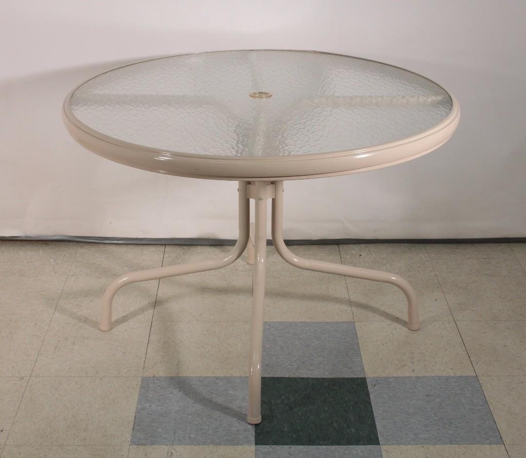 Glass Top Patio Table: Outdoor table measures 41" wide x 29" tall, metal base with glass top, in new condition, has hole for umbrella.
