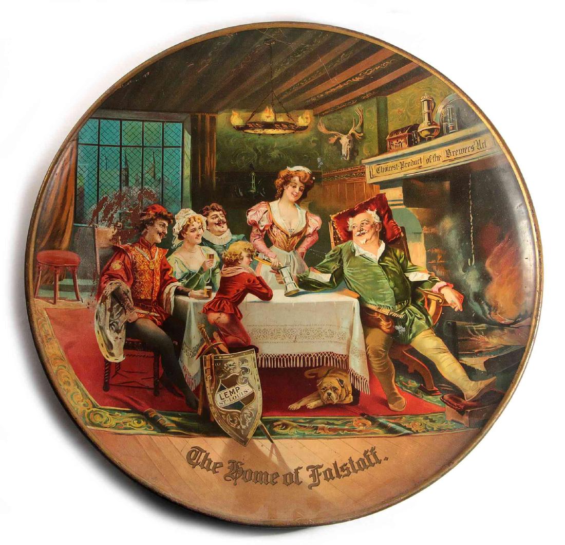 A LEMP BEER 'HOME OF FALSTAFF' ADVERTISING CHARGER: A pre-prohibition era large tin litho charger in colorful display of an interior scene with Fakstaff at fireside with his head on a pillow and stein being filled from a bottle with Lemp beer logo, a s