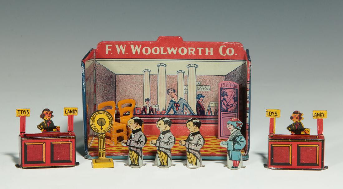A MINIATURE TIN LITHO F.W. WOOLWORTH CO. STORE: A miniature F.W. Woolworth Company Hometown store, a tinplate diorama with lithographic graphics, the imagery portrays shoppers and clerks behind a perfume counter, additional free-standing die-cut ti