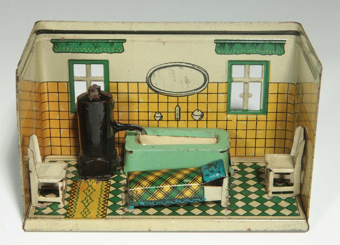 AN OROBRE GERMAN TIN LITHO DOLL HOUSE BATHROOM: With two chairs, water heater, tub, and day bed. Marked 'Made in Germany OROBRE' on the inside wall. Measures 3.25 x 5 x 2.5 inches. We happily provide seamless in-house packing and shipping services 