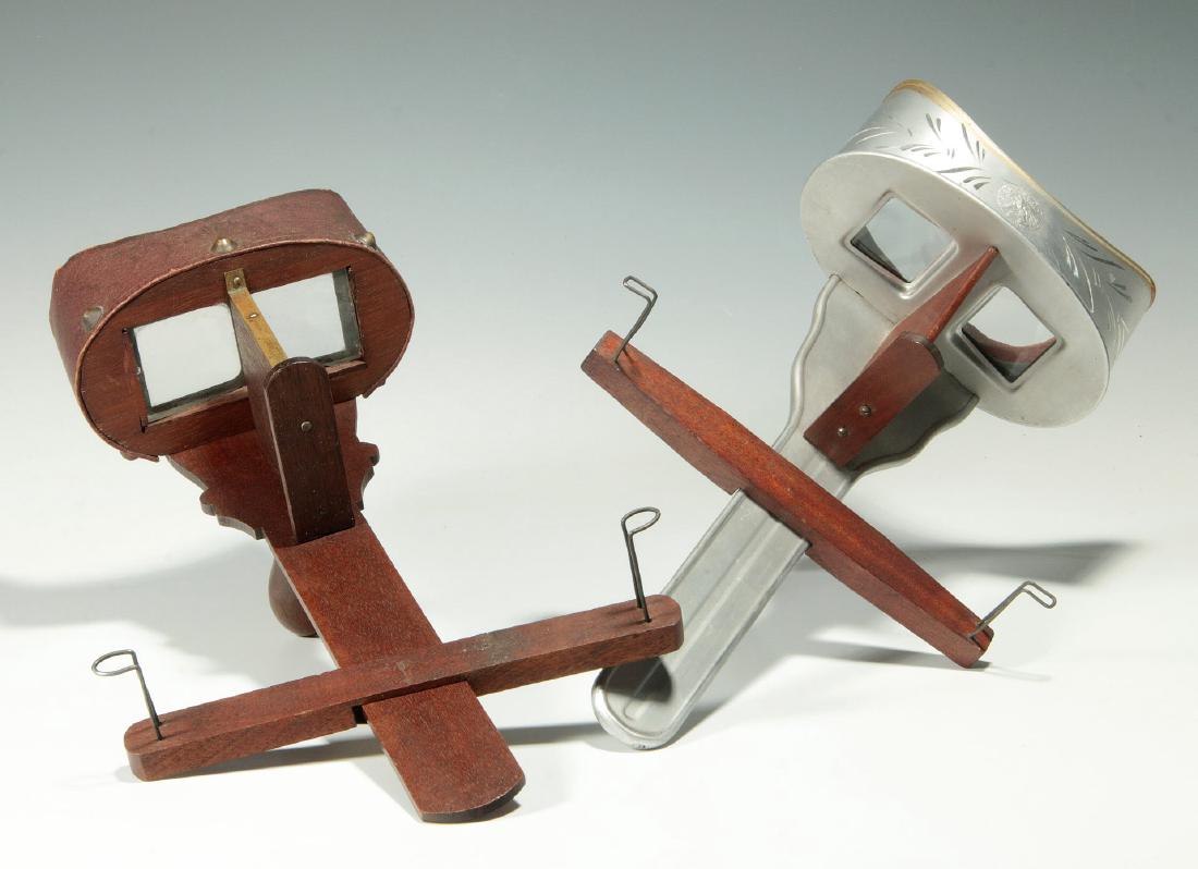 TWO CIRCA 1900 STEREO CARD VIEWERS: One aluminum example with Exposition Award Medallion. Measure 12 and 12.5 inches each. We happily provide seamless in-house packing and shipping services on nearly everything we sell.