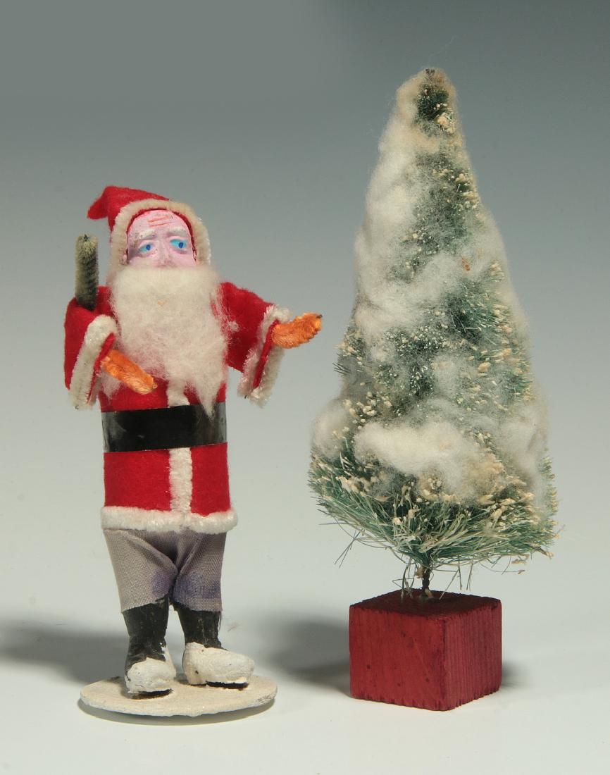 A VINTAGE COMPOSITION FACE SANTA CLAUS FIGURE: A standing figure of father Christmas, stamped ink markings 'Made in Japan' on the base; plus a vintage Christmas tree. Measure 5 and 6 inches each. We happily provide seamless in-house packing and sh