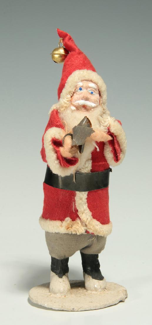 A VINTAGE COMPOSITION FACE SANTA CLAUS FIGURE: A standing figure of father Christmas, stamped ink markings 'Made in Japan' on the base. Measures 6 inches. We happily provide seamless in-house packing and shipping services on nearly everything we s