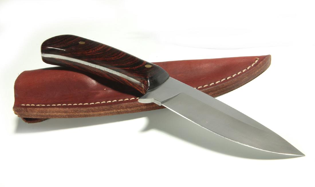 A CUSTOM MADE SKINNING KNIFE W/ ZEBRA WOOD HANDLE: A modern, high quality knife with sheath. Knife measures 9 inches. We happily provide seamless in-house packing and shipping services on nearly everything we sell.
