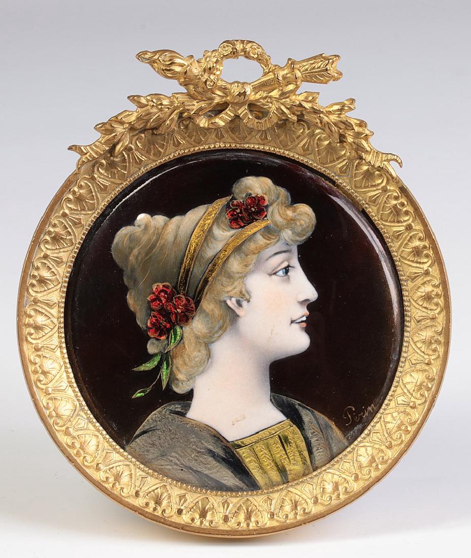 A FRENCH ENAMEL ON COPPER PORTRAIT SIGNED PERIN: An enamel on copper portrait in ormolu frame centering a profile bust portrait of young woman in Renaissance dress, within an easel back gilt frame with stylized border surmounted by a ribbon and trop